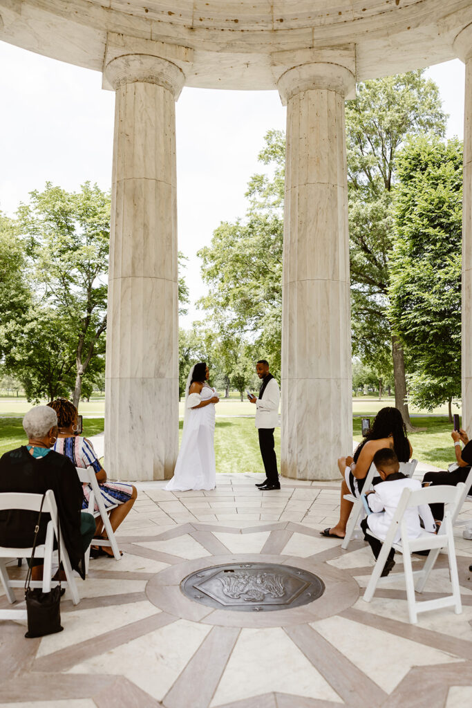 the wedding couple at the DC War Memorial getting married