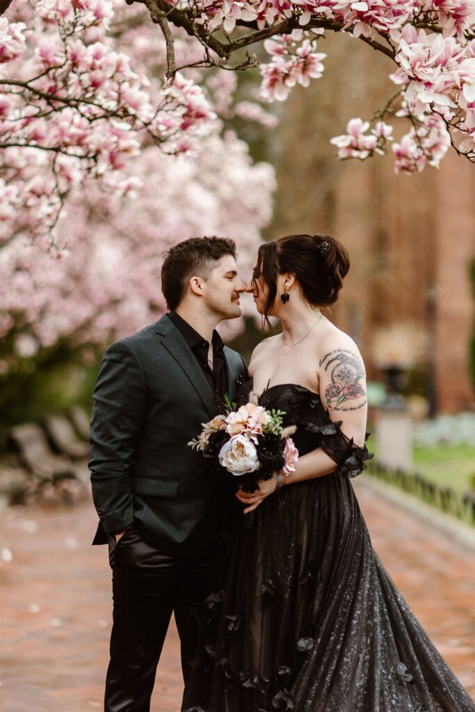 bride and groom surrounded by cherry blossoms during their dc elopement