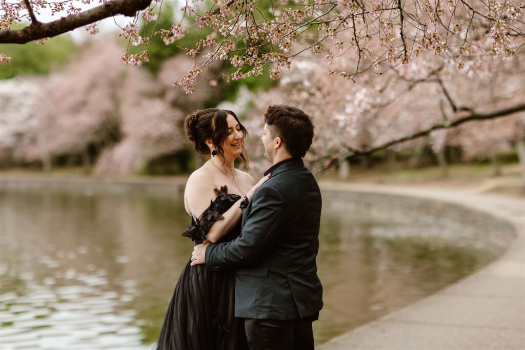 bride and groom surrounded by cherry blossoms during their dc elopement