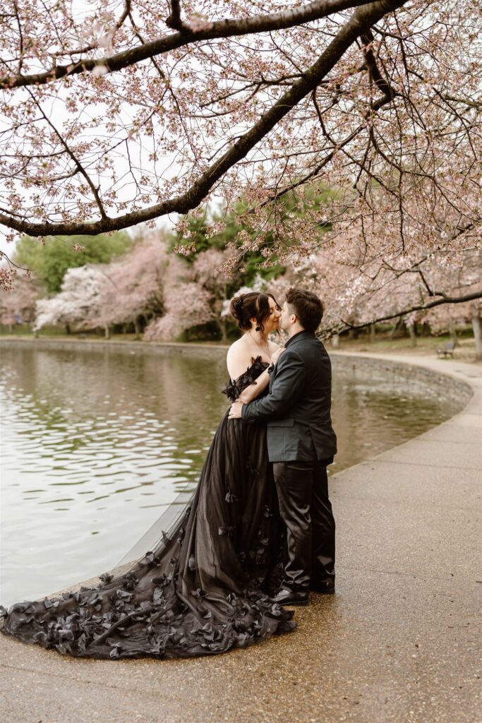 bride and groom surrounded by cherry blossoms during their dc elopement