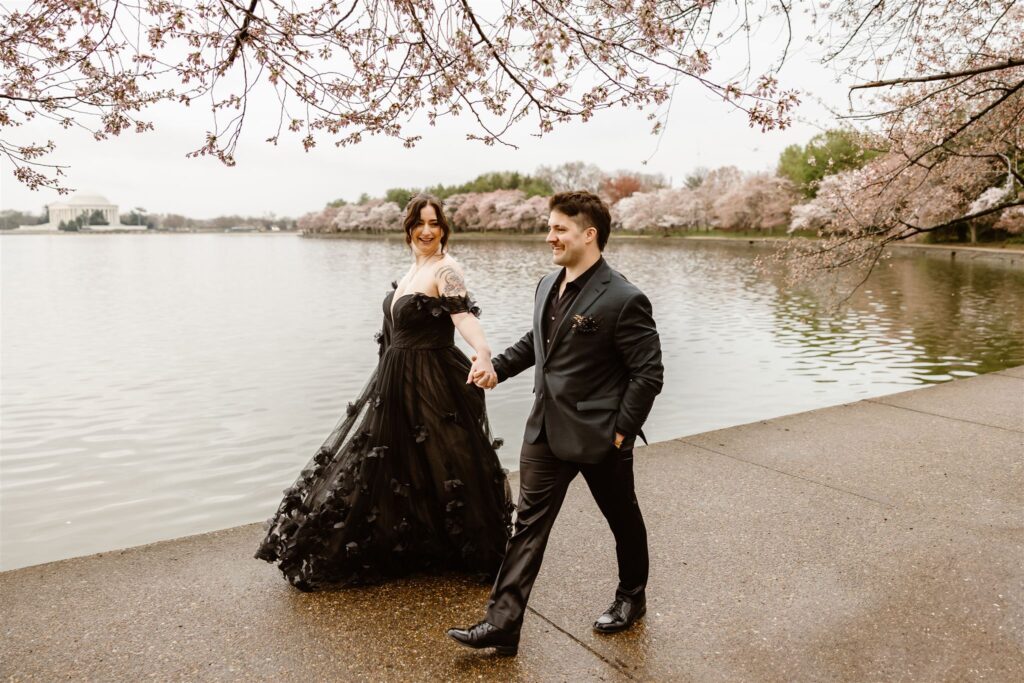 bride and groom surrounded by cherry blossoms during their dc elopement