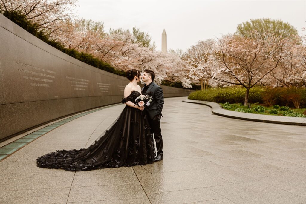 bride and groom surrounded by cherry blossoms during their dc elopement