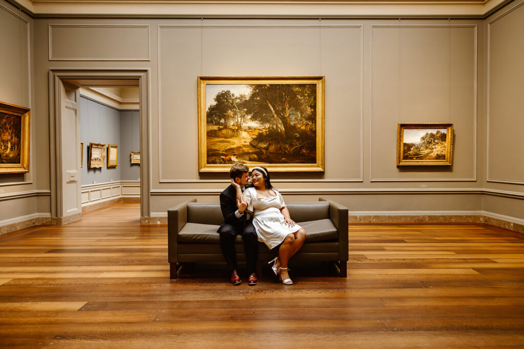 the wedding couple sitting on the couch during their elopement photos in DC