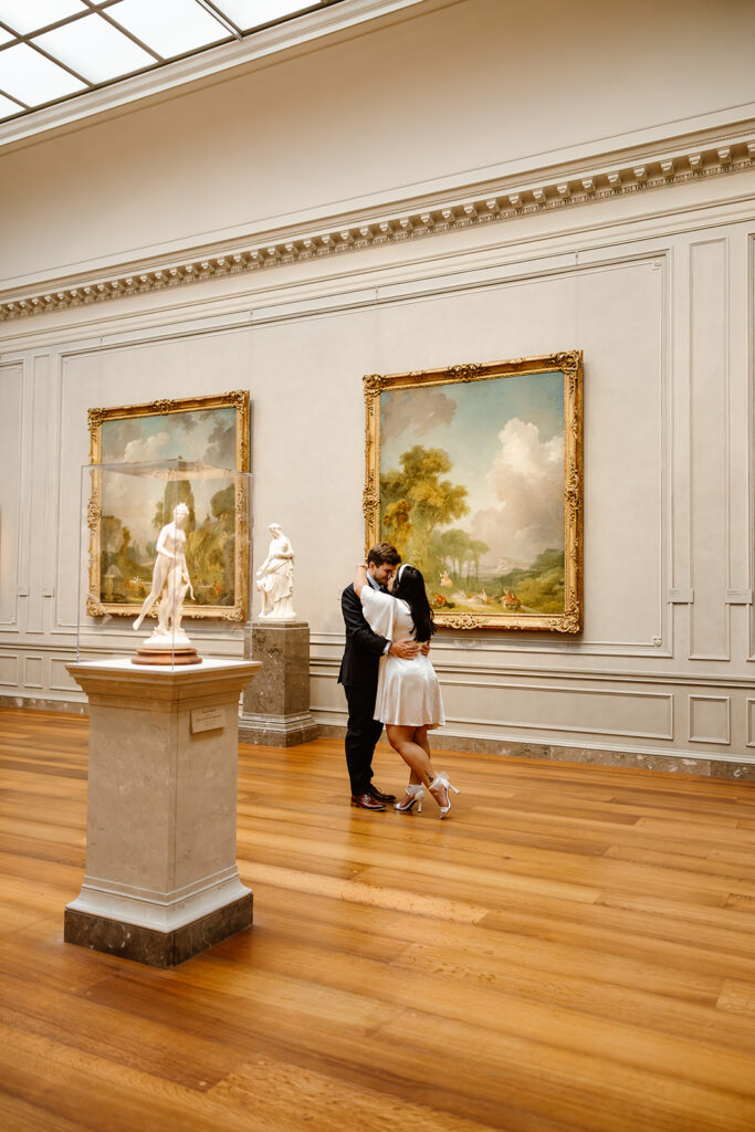 the elopement couple embracing by the art in the National Gallery of Art