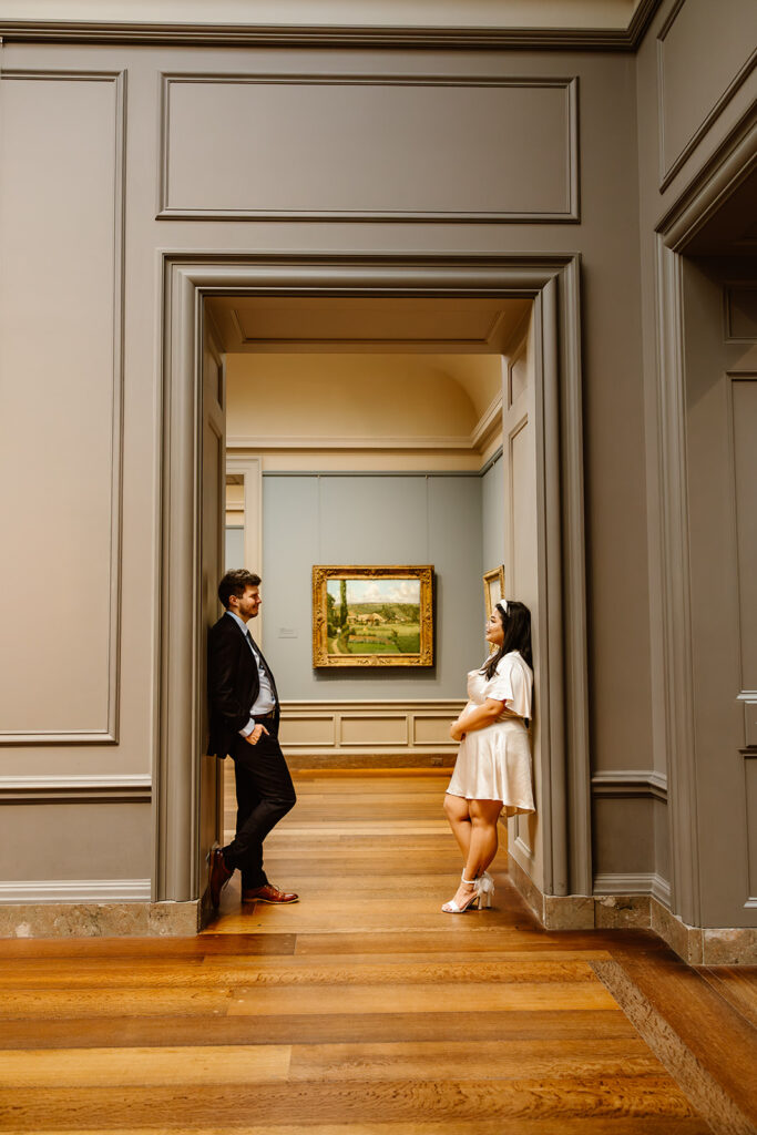 the elopement couple leaning against the door frame in an art exhibit at the National Gallery of Art