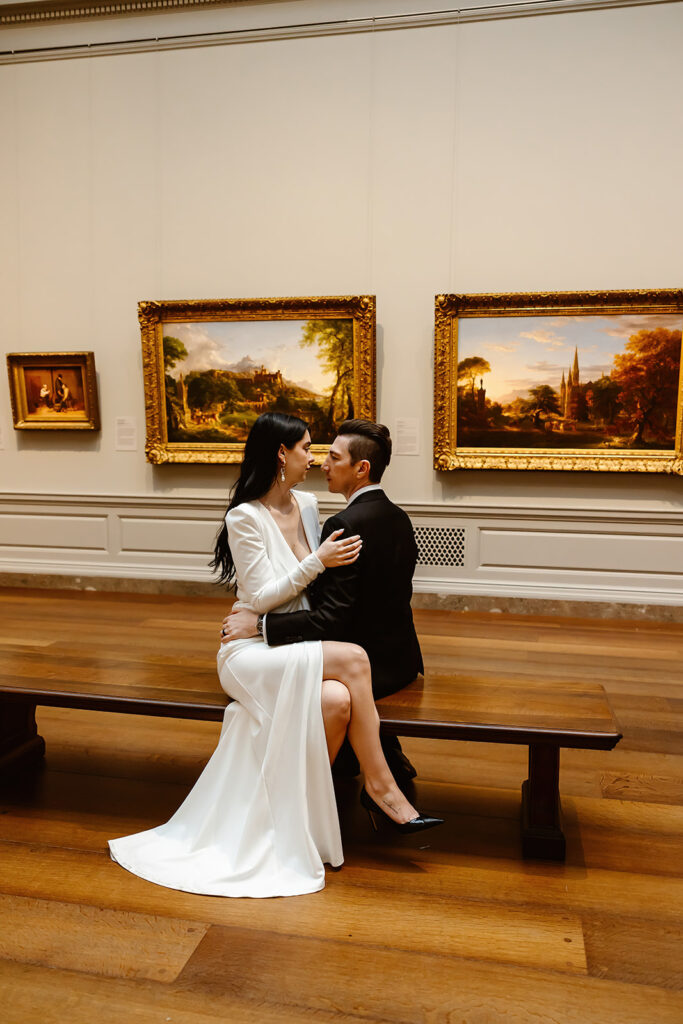 the wedding couple sitting on the benches at the National Gallery of Art