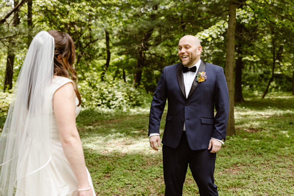 the groom turning around to see the bride during their first look