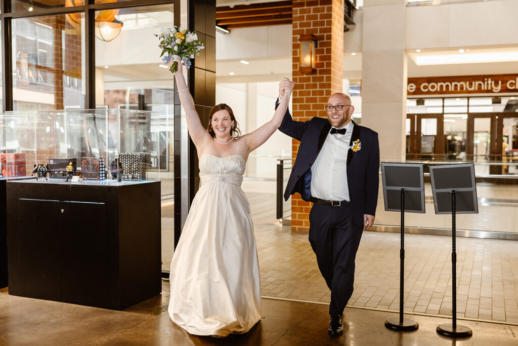 the wedding couple walking into their reception