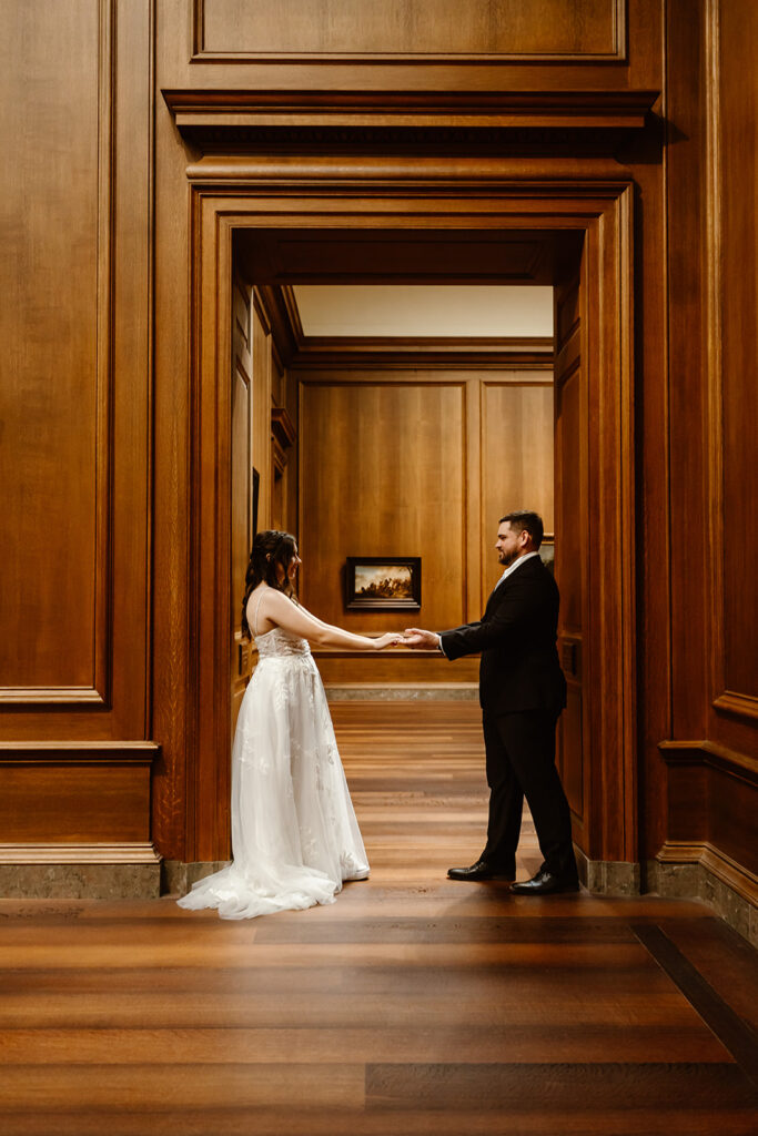 the wedding couple standing in a doorway at the National Gallery of Art