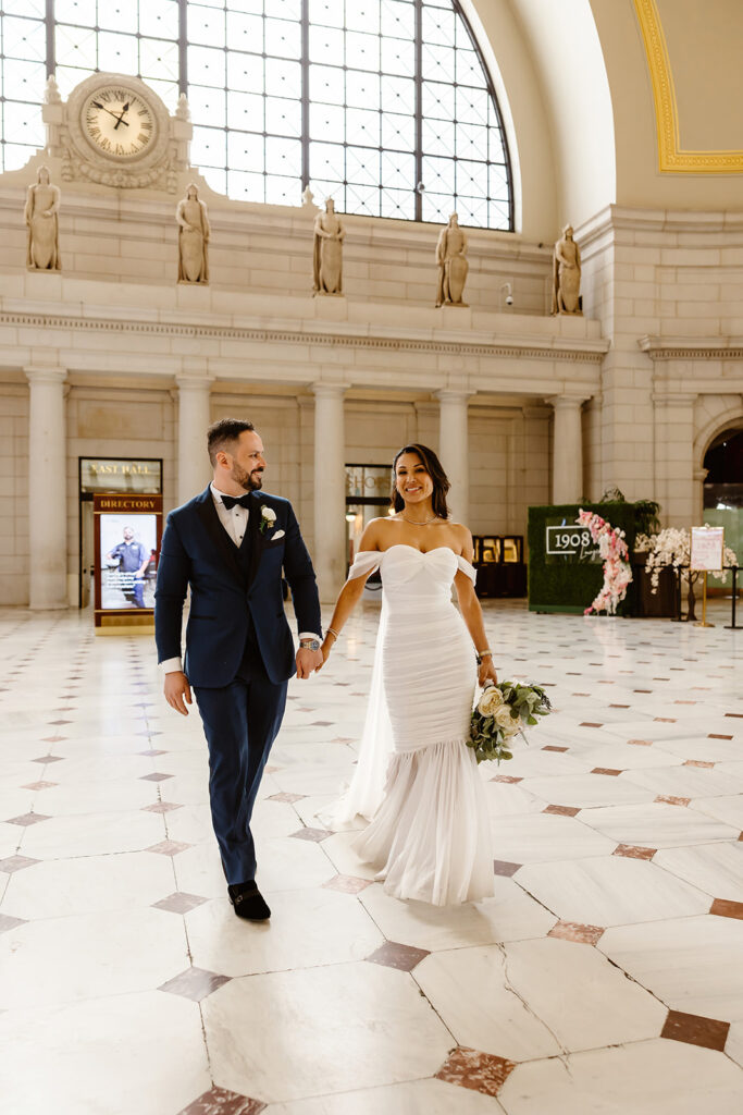 the wedding couple walking through the Union Station