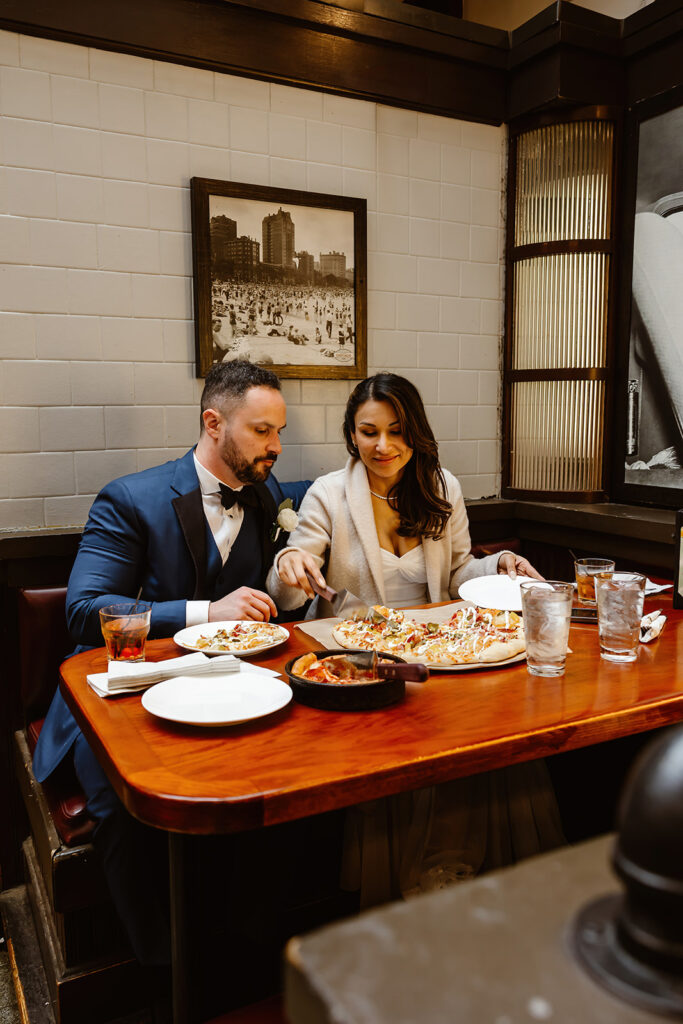 the wedding couple eating pizza at the Union Station for their DC elopement