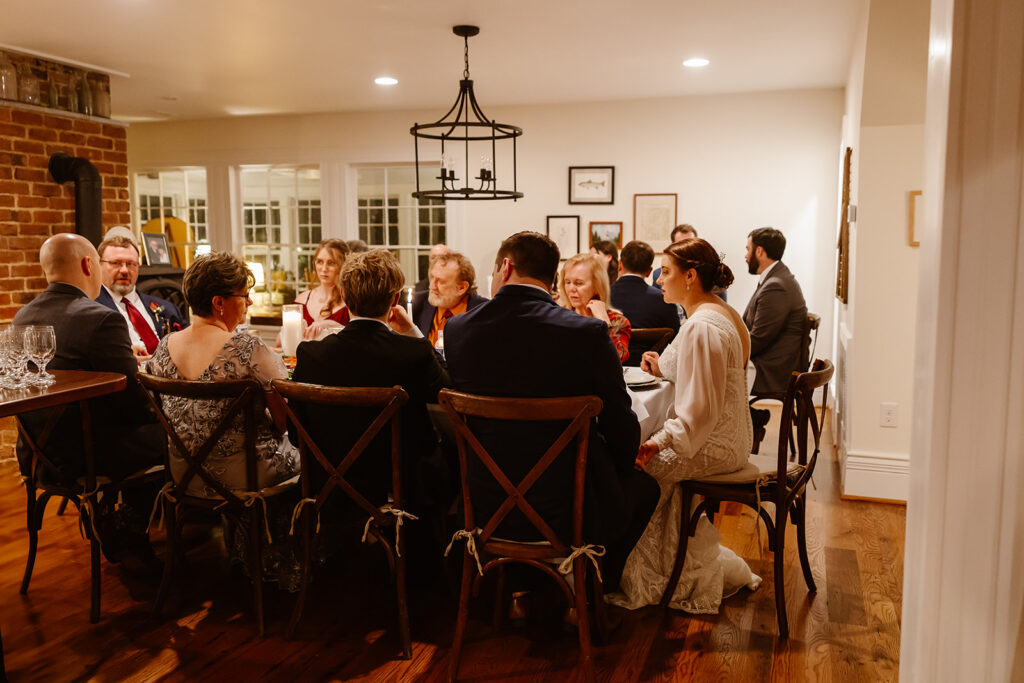 the wedding couple eating dinner with their friends and family in VRBO