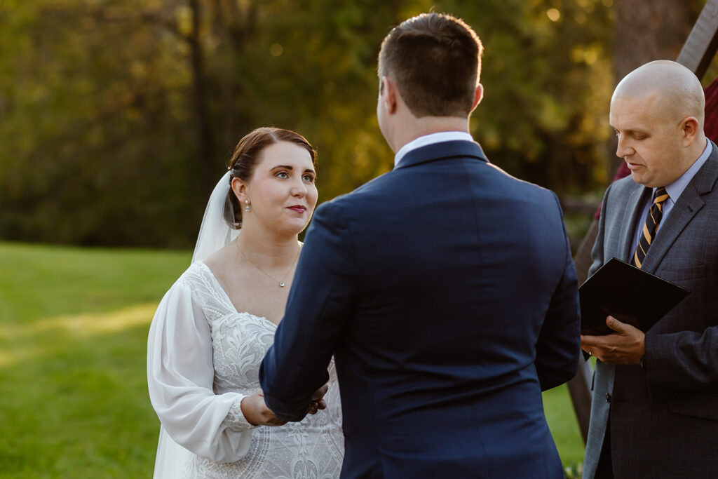 Bride looks at the groom during the wedding ceremony.