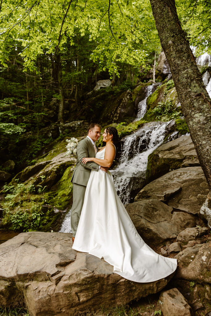 the wedding couple at a waterfall for elopement photos