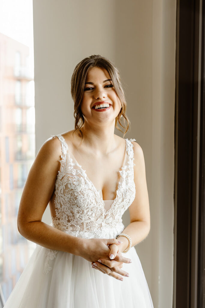 the bride smiling as she gets ready before the first look 