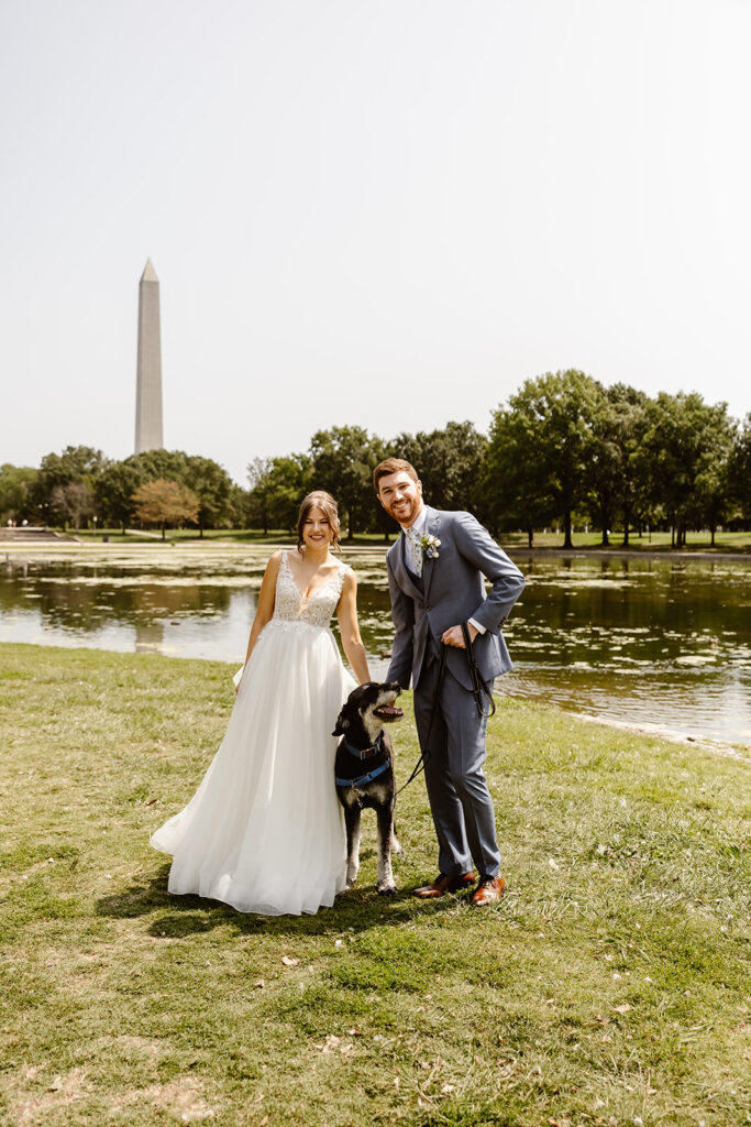 the wedding couple posing for wedding photos with their dog