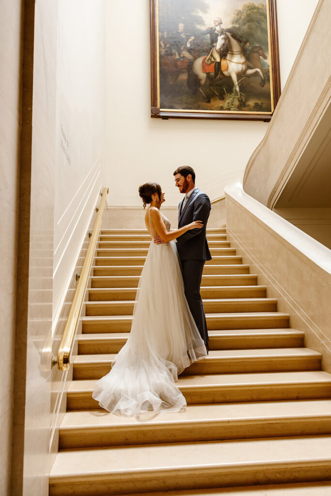 the wedding couple at the staircase at the National Gallery of Art