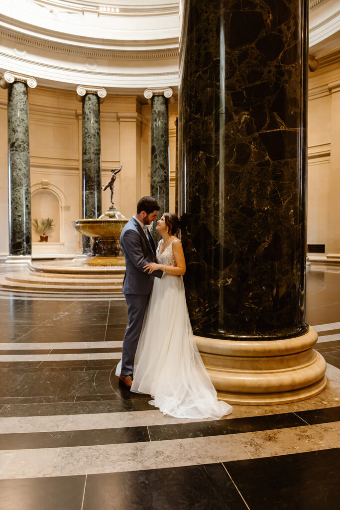 the wedding couple by the pillars in the National Gallery of Art