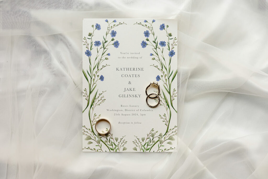 wedding flatlay with wedding invitation and wedding rings