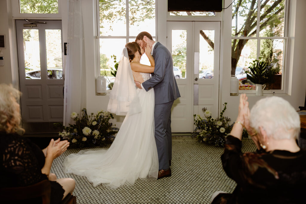 the bride and groom kissing at their wedding ceremony