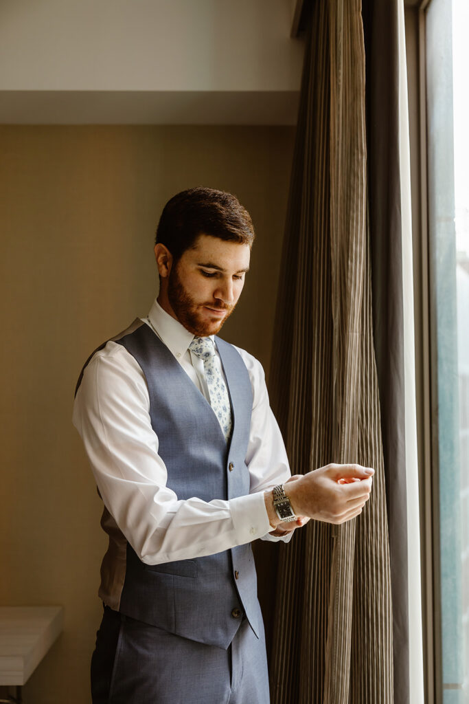 the groom getting ready for the wedding day 