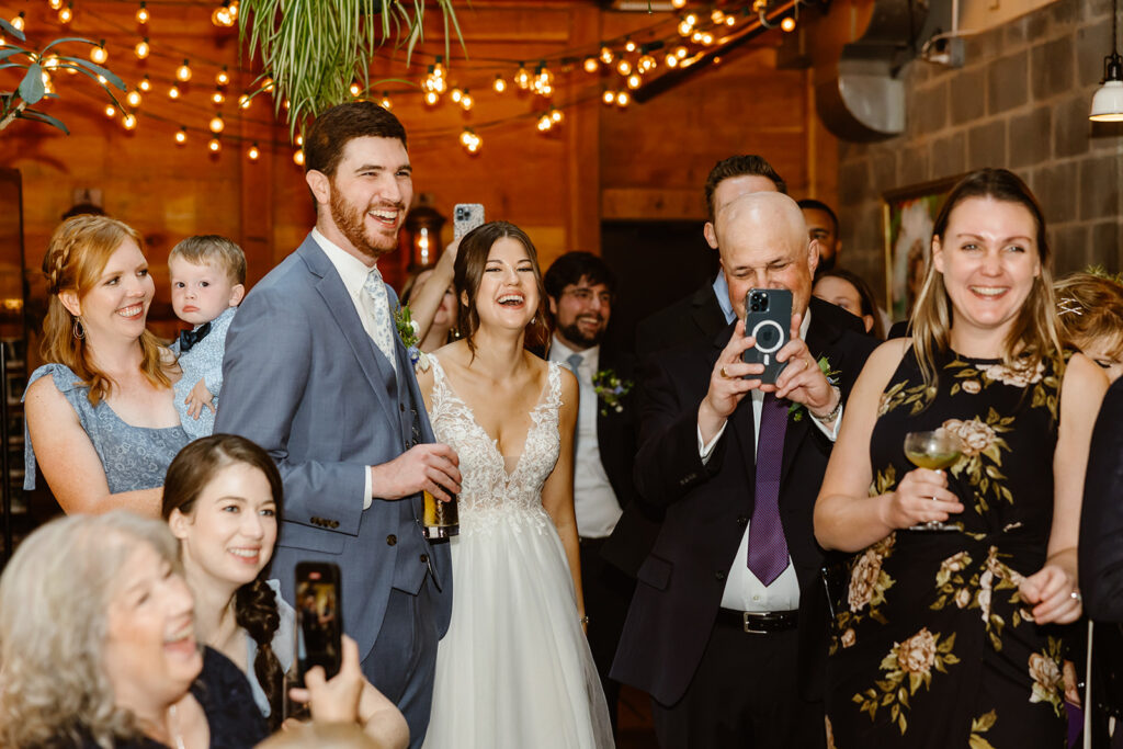 the bride and groom celebrating with their guests