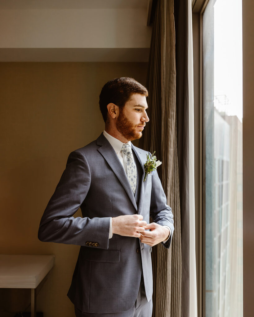 the groom getting ready for the DC wedding in the hotel room