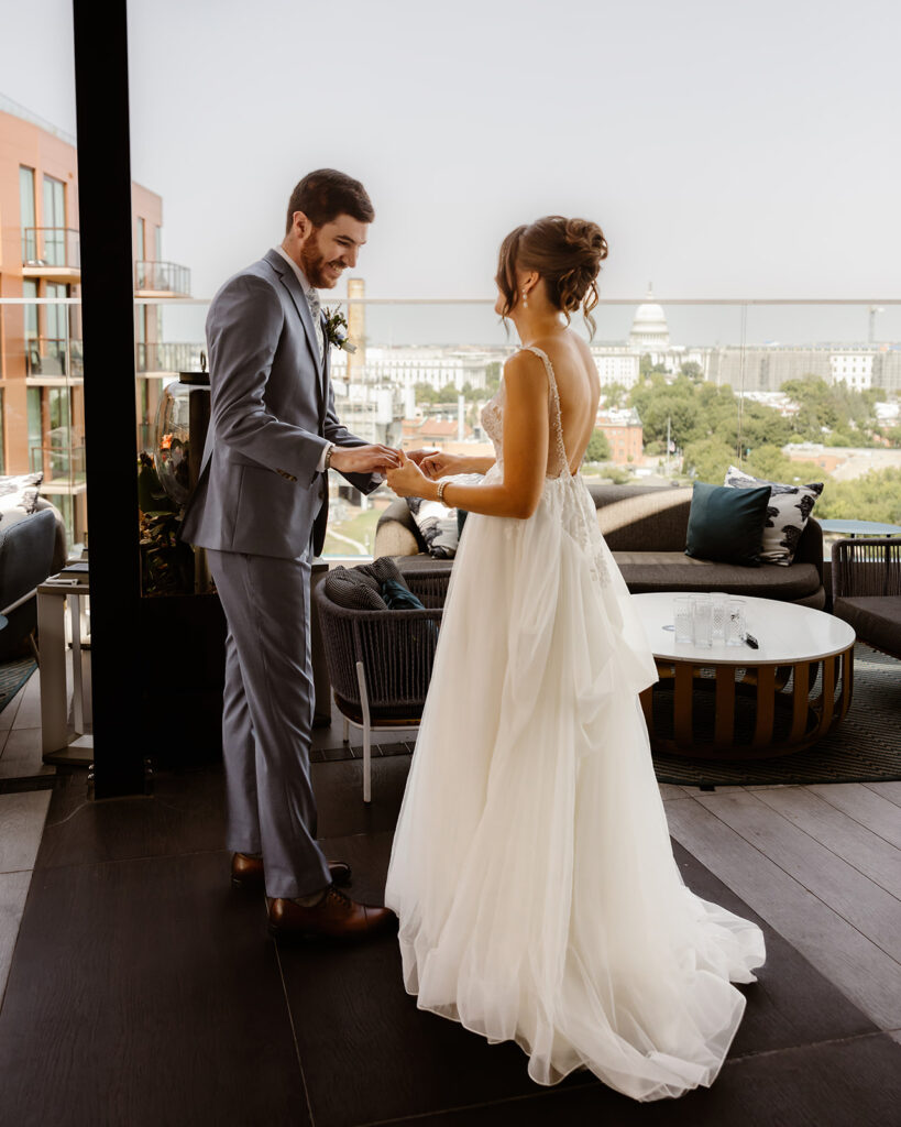 the wedding couple's first look on the rooftop of the hotel