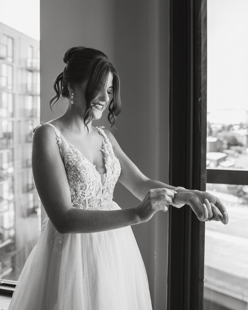 black and white wedding photo of bride getting ready 