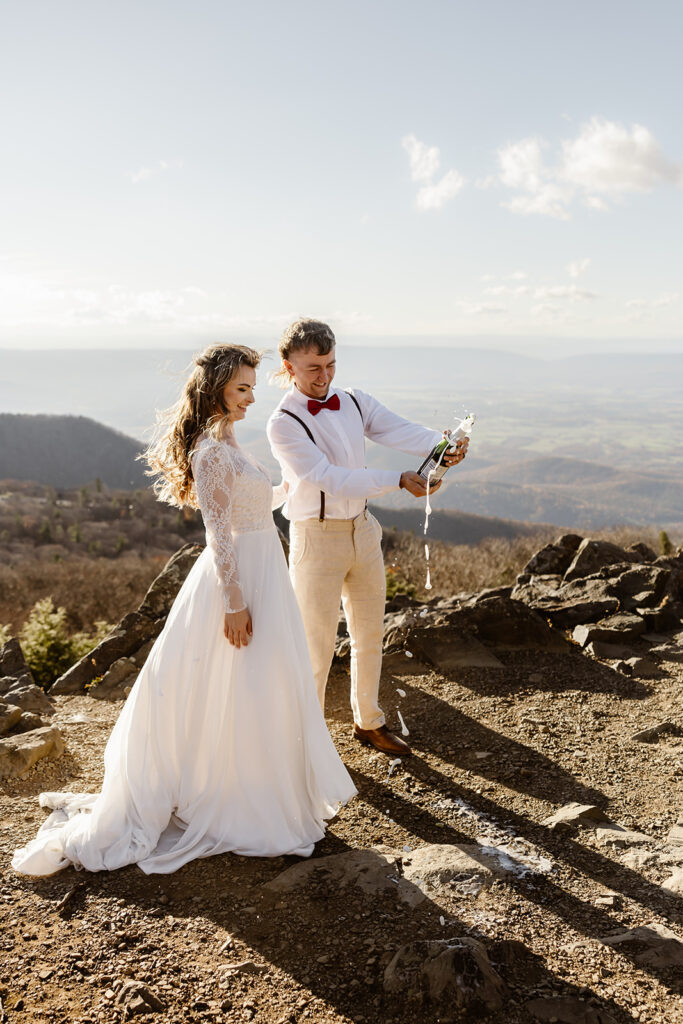 the wedding couple celebrating their elopement with champagne