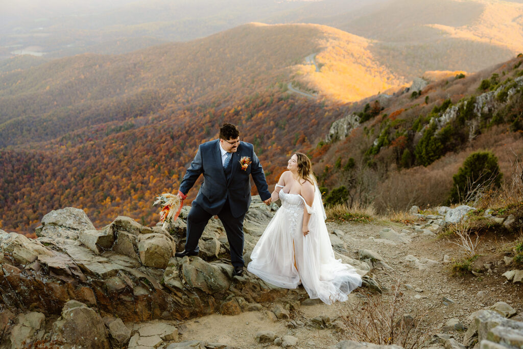 the wedding couple hiking together at Shenandoah National Park