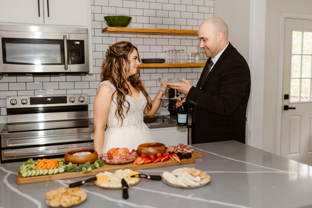 couple enjoying breakfast charcuterie and champagne during their vrbo wedding morning