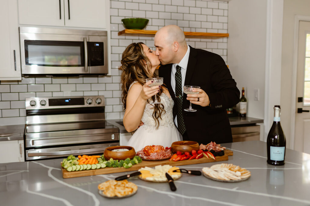 couple enjoying breakfast charcuterie and champagne during their vrbo wedding morning