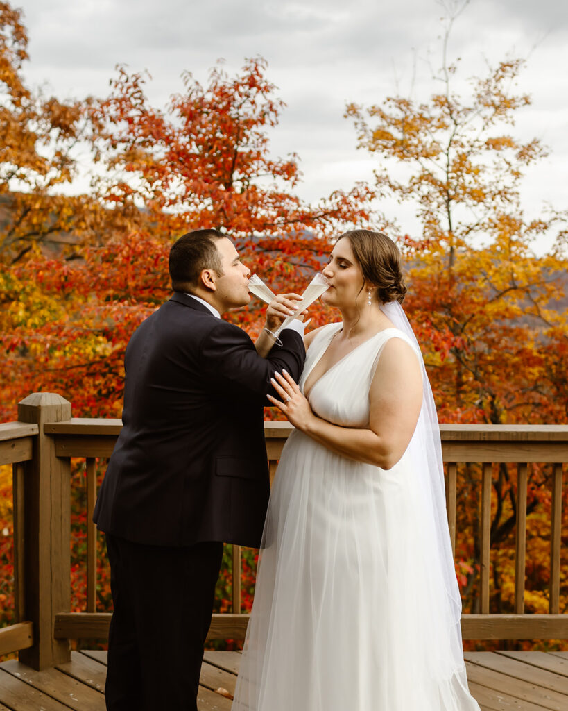 elopement couple drinking champagne on the balcony of their vacation rental