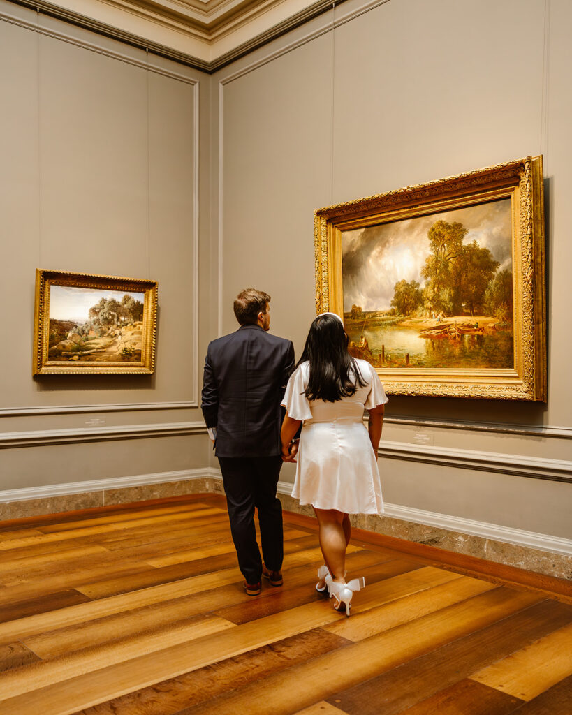 the couple walking though the art museum together