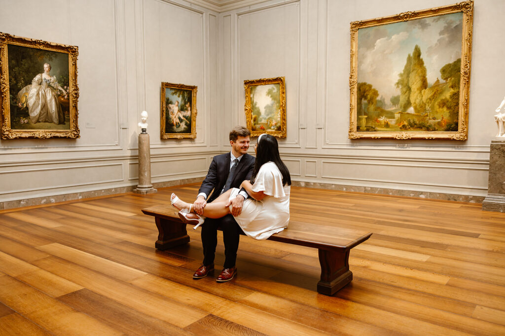 the couple sitting on the benches at the National Gallery of Art
