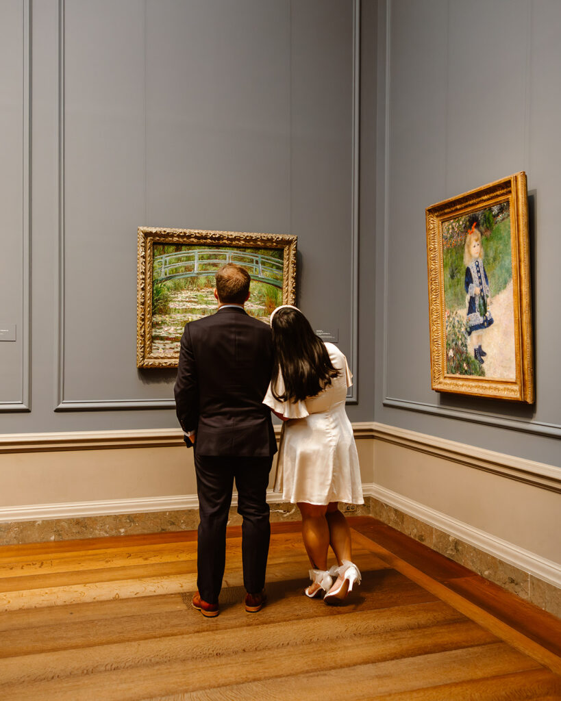 the couple walking though the art museum together
