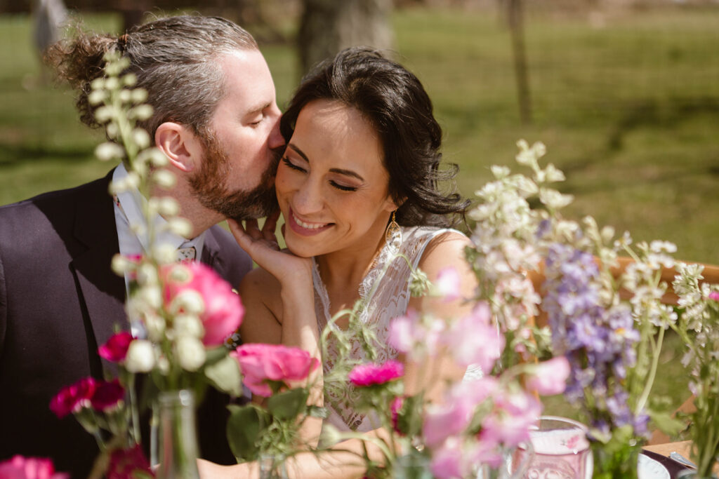 groom kissing bride on the cheek at one of Maryland's elopement locations