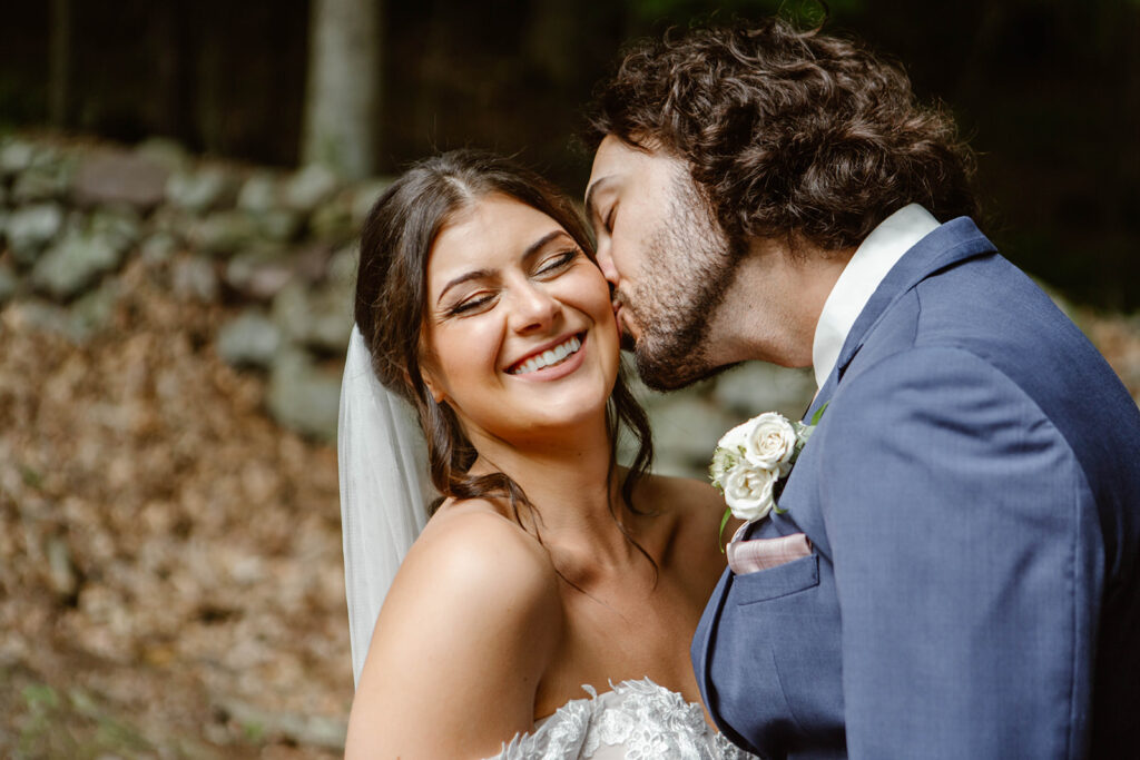 groom kissing bride on the cheek during their maryland elopement
