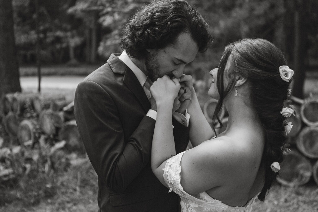 groom kissing his bride's hands
