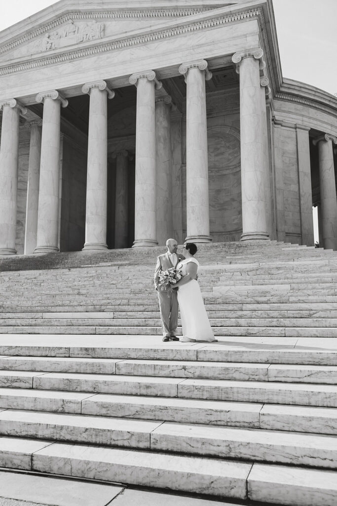 elopement couple exploring washington dc during their cherry blossom wedding day