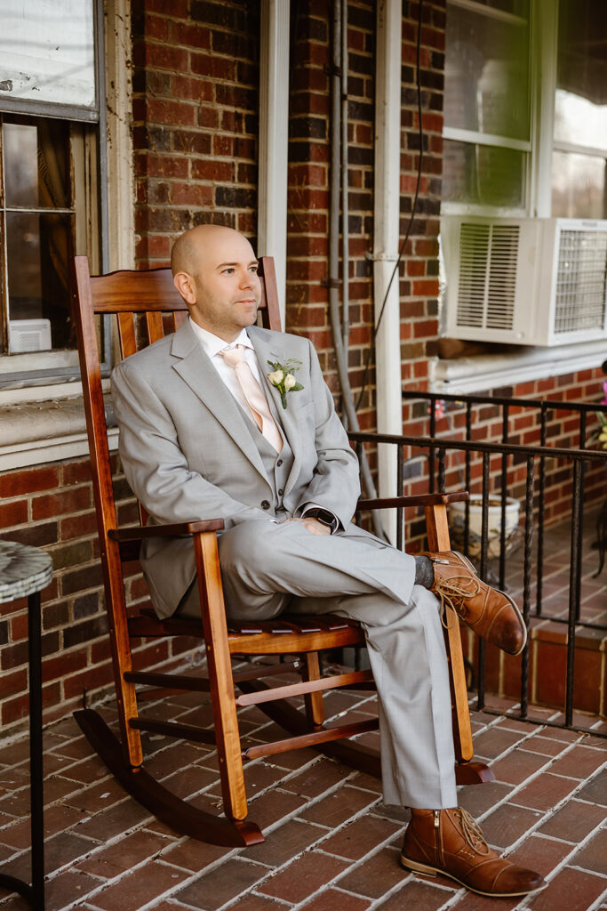 groom portrait outside the couple's red brick home