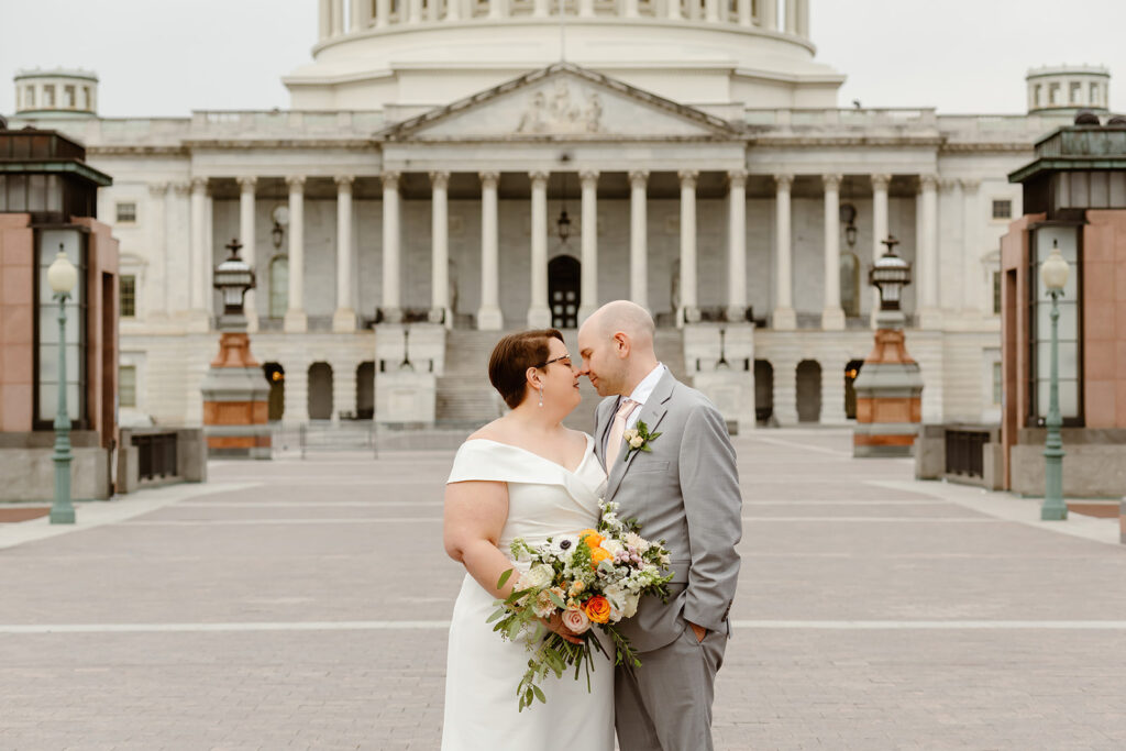 elopement couple exploring washington dc during their cherry blossom wedding day
