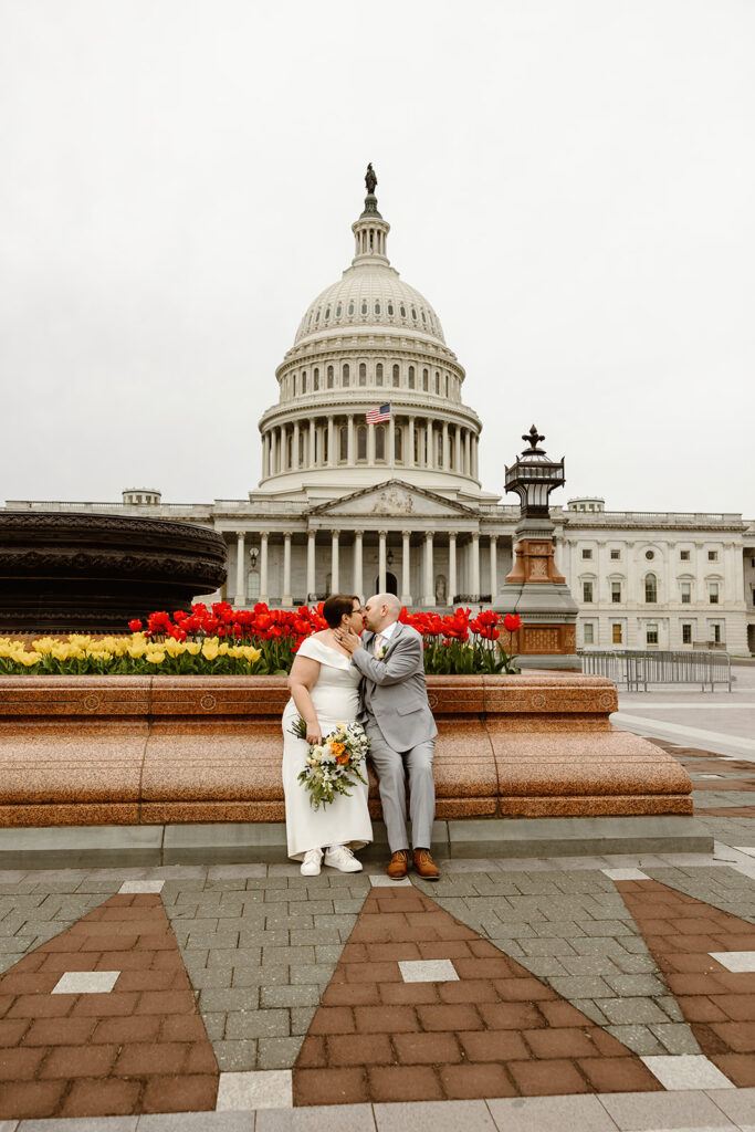 bride and groom exploring the area of library of congress in dc during their cherry blossom wedding elopement