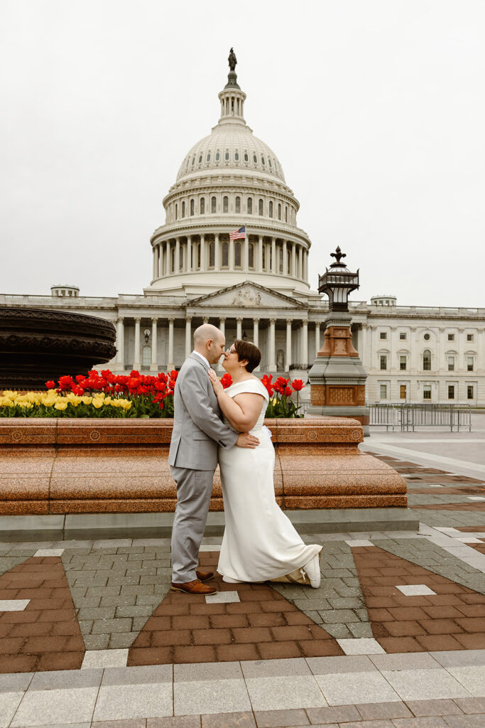 bride and groom exploring the area of library of congress in dc during their cherry blossom wedding elopement