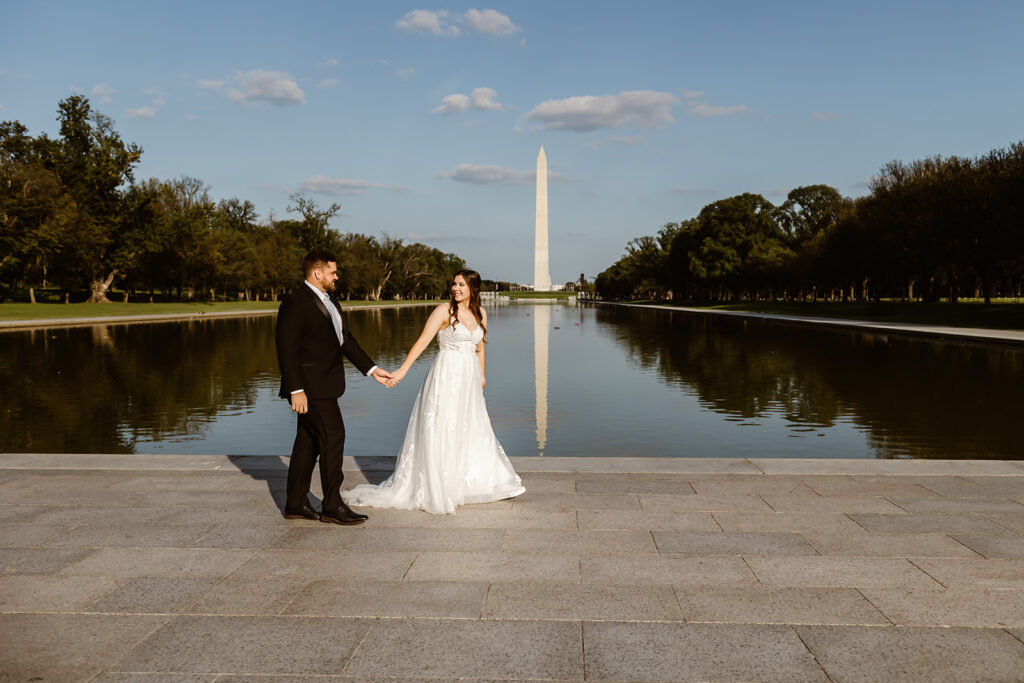 elopement couple holding hands and walking at the national mall area