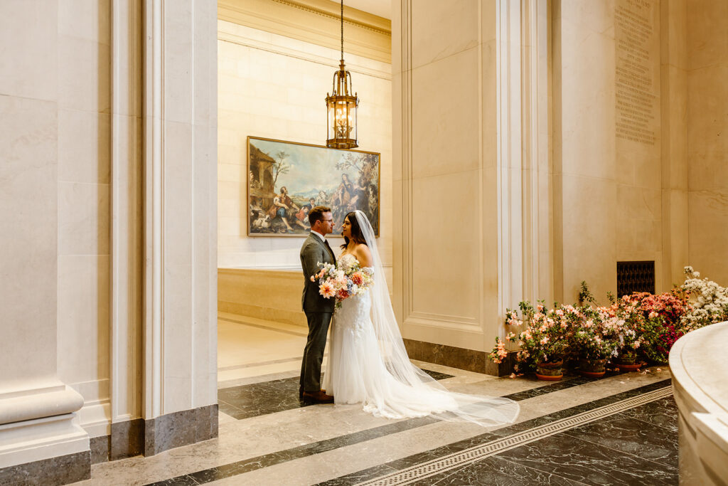 the wedding couple holding hands at the National Gallery of Art