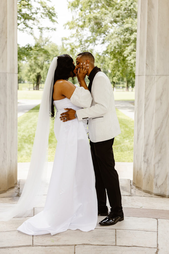 wedding couple kissing during their dc war memorial wedding on the front steps