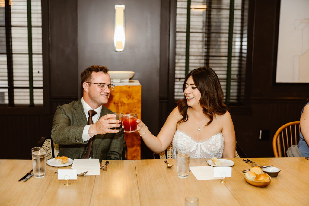 elopement couple celebrating their day with a toast