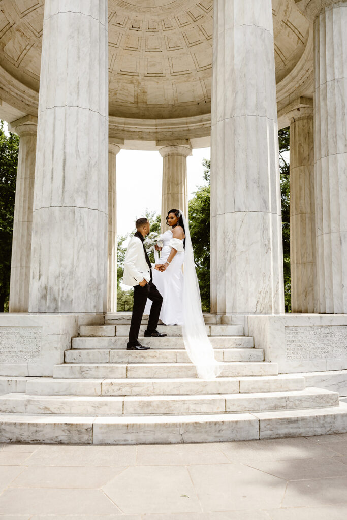 wedding couple posing during their dc war memorial, washington dc elopement on the front steps